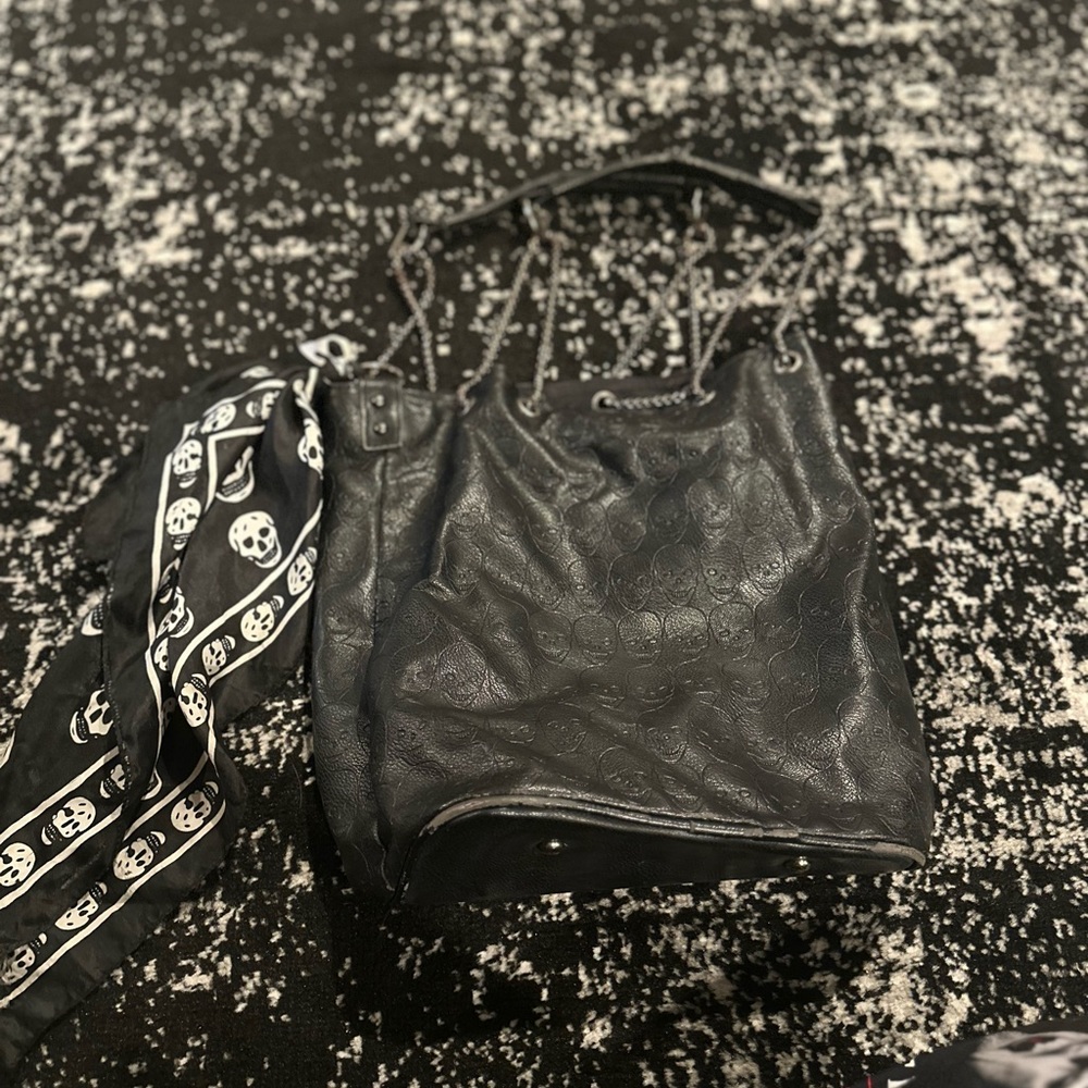 Black skull purse with cute scarf.
